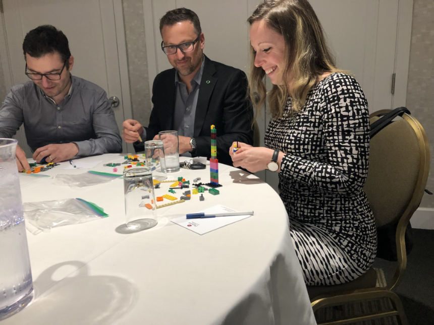 A participant in a good mood, designing her Lego creation.